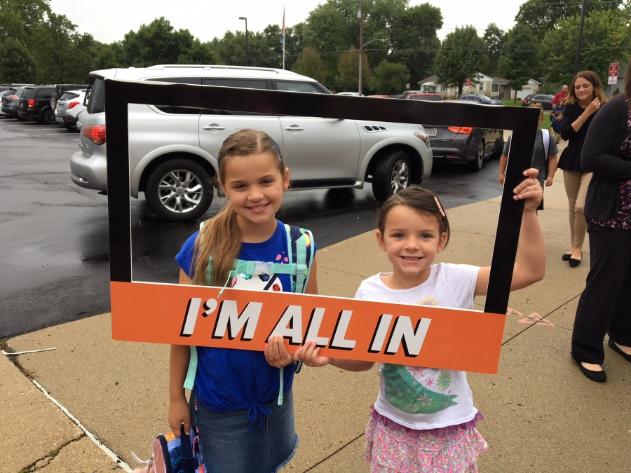 people holding a frame sign